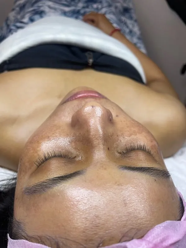 Client receiving a relaxing facial treatment